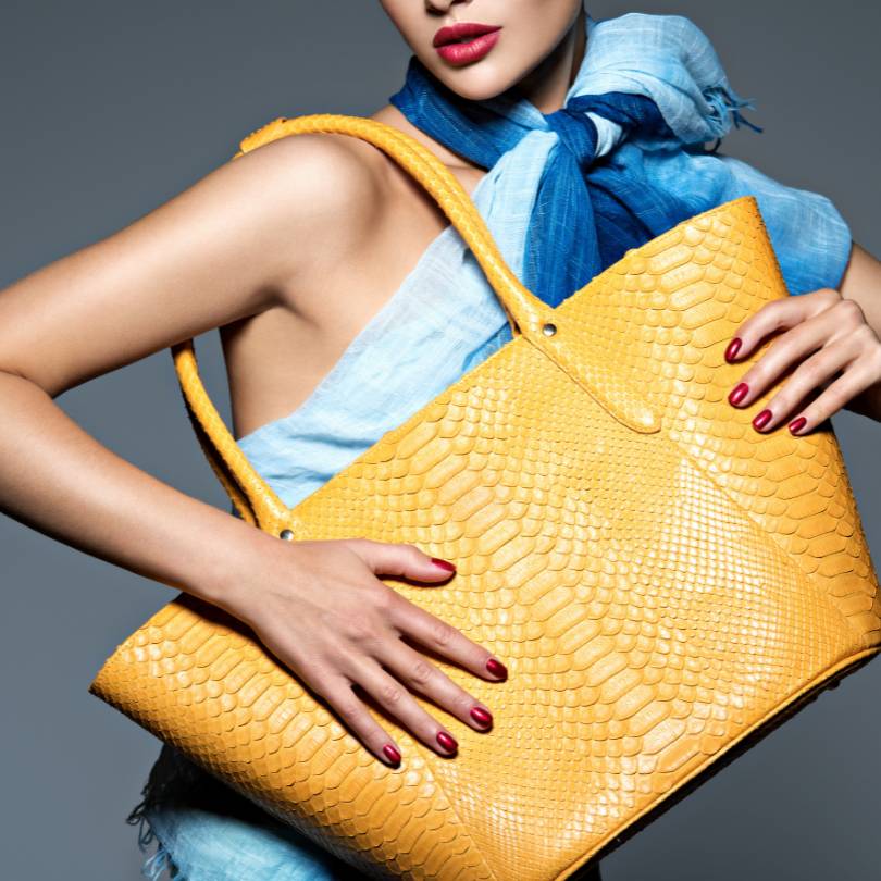 woman holding yellow handbag